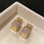 The exquisite earrings adorned with dazzling zircon gemstones, radiating elegance and sophistication. These square golden earrings are a symbol of luxury and make for the perfect Christmas gift for women, adding a touch of cuteness to any outfit.