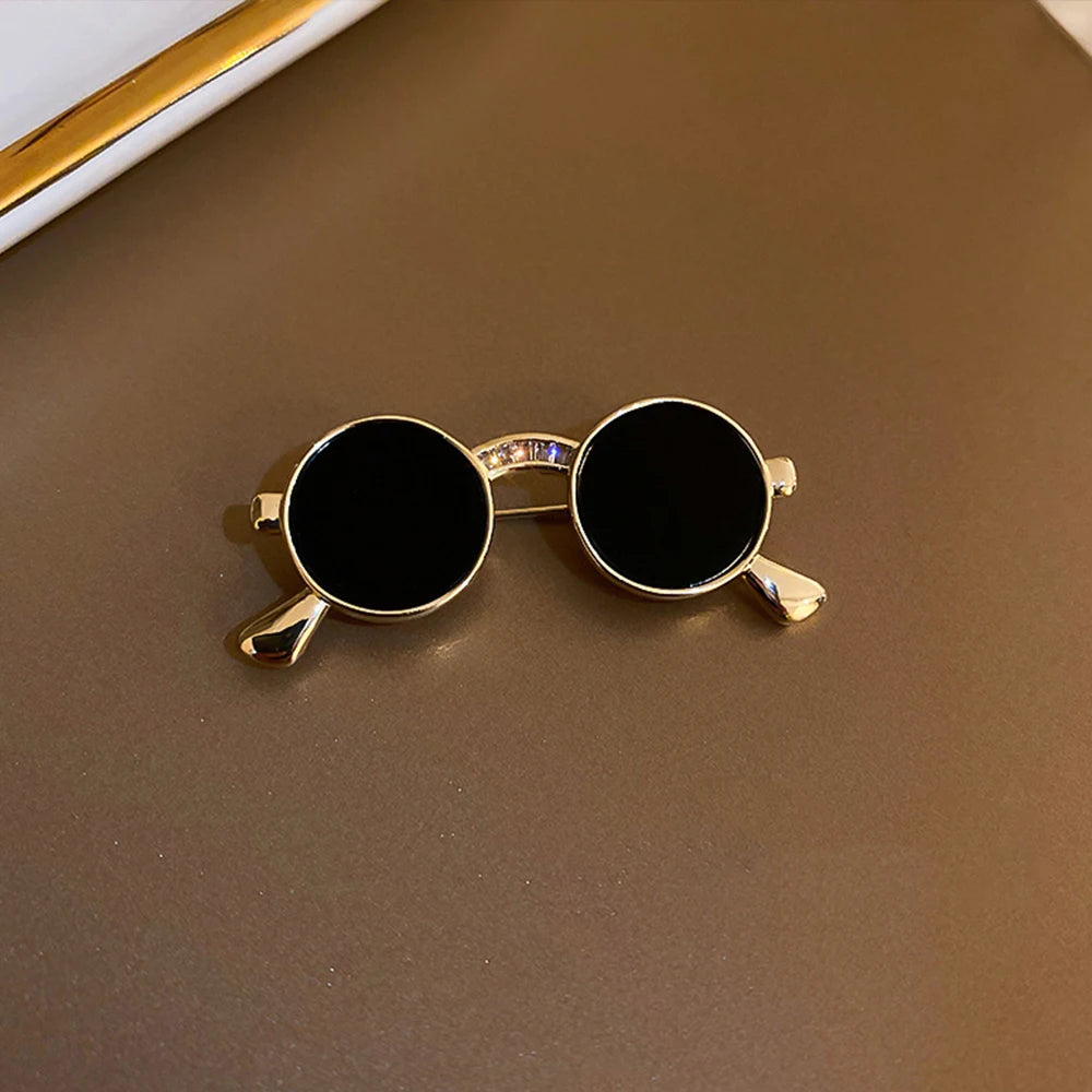 Unique vintage metal glasses shaped pins that add a touch of punk style to your outfit. These mini sunglasses brooches are perfect for both women and men, making them versatile accessories for any party or special occasion. Elevate your clothing game with these trendy and eye-catching pieces.