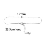 This anklet is made of 304 stainless steel and features a round heart chain design in a silver color, perfect for women to wear during the summer at the beach.
