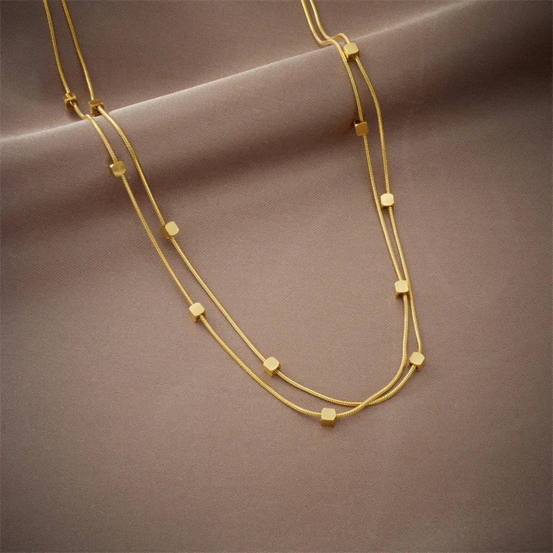 This necklace is made of 316L stainless steel and features a 2-in-1 design with small cube chains. It is available in gold and silver colors, making it a stylish accessory for women. This choker necklace is perfect for parties and also makes a great jewelry gift for girls.