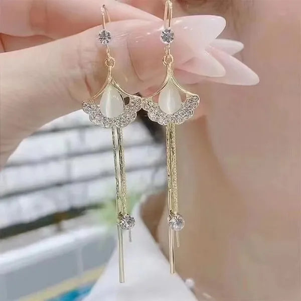 The allure of these exquisite French vintage earrings adorned with red maple leaf crystals and zircon stones. These elegant tassel earrings are designed to enhance a woman's temperament and add a touch of glamour to any party ensemble. They make a perfect gift for someone special who appreciates fine jewelry.