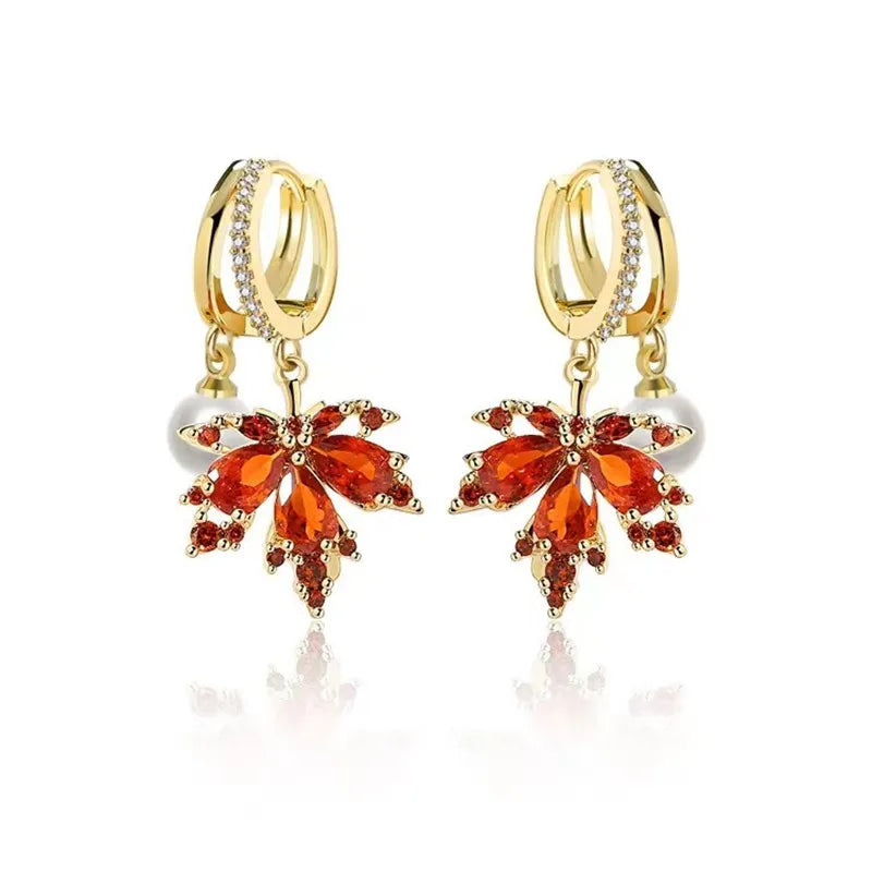 The allure of these exquisite French vintage earrings adorned with red maple leaf crystals and zircon stones. These elegant tassel earrings are designed to enhance a woman's temperament and add a touch of glamour to any party ensemble. They make a perfect gift for someone special who appreciates fine jewelry.