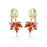 The allure of these exquisite French vintage earrings adorned with red maple leaf crystals and zircon stones. These elegant tassel earrings are designed to enhance a woman's temperament and add a touch of glamour to any party ensemble. They make a perfect gift for someone special who appreciates fine jewelry.