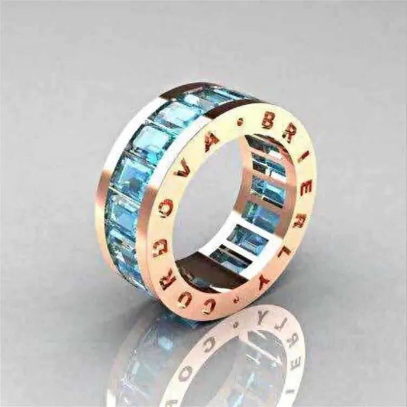 Experience the allure of our classical gold color rings for women, enhanced with trendy metal inlays and mesmerizing blue stones, perfect for weddings and engagements.